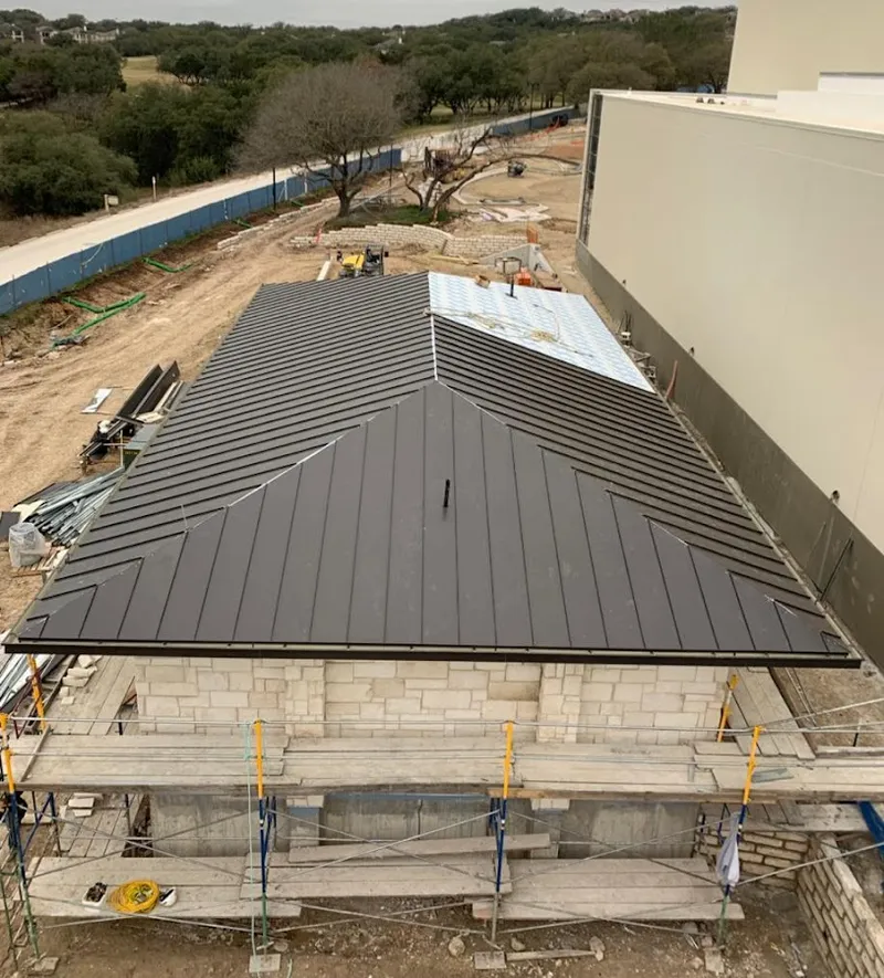 Metal roof new construction with scaffolding in Bolton